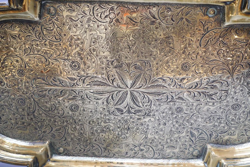 A 19th century Middle - Eastern engraved brass tray, 53cm wide
